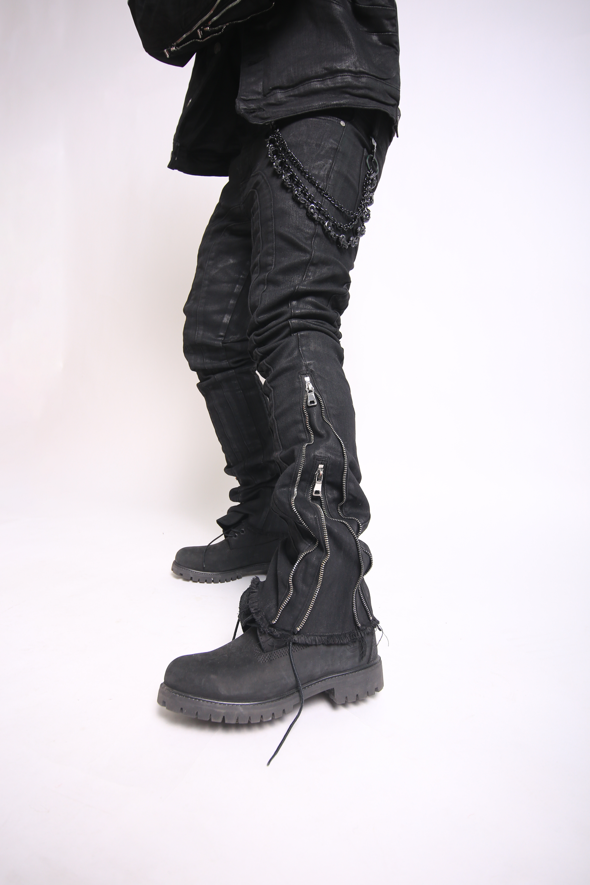 Black leather boots and pants on a white background