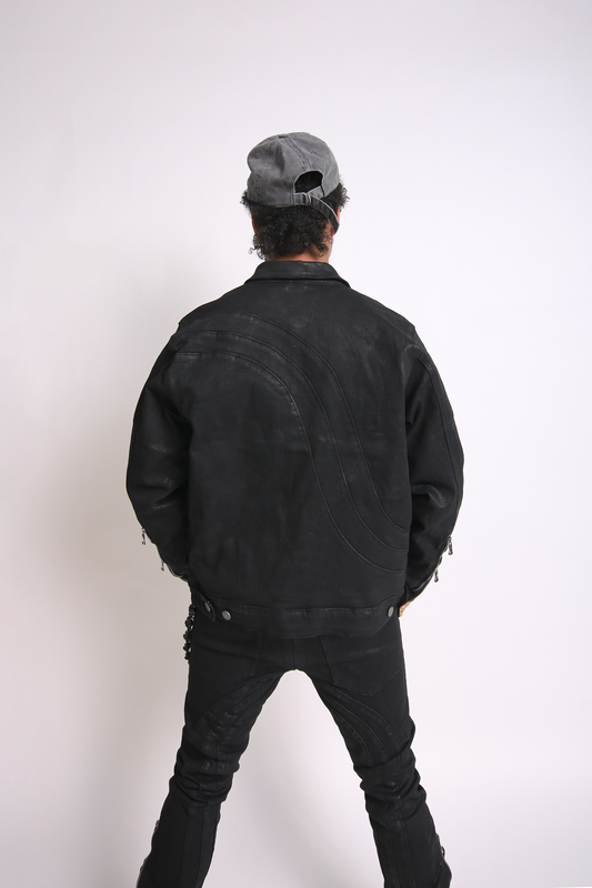 Person wearing a black jacket and pants with a gray cap on a white background