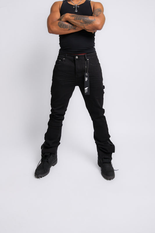 Person wearing black tank top and black pants with visible branding on a white background