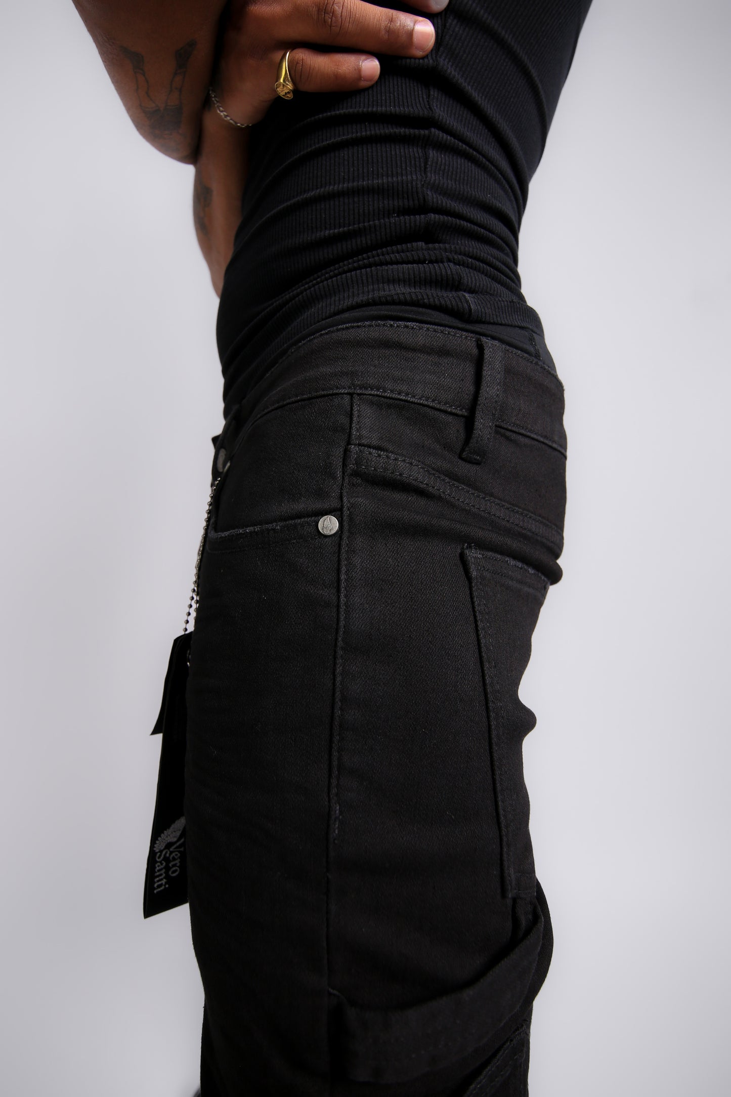 Black cargo pants with visible branding on a white background