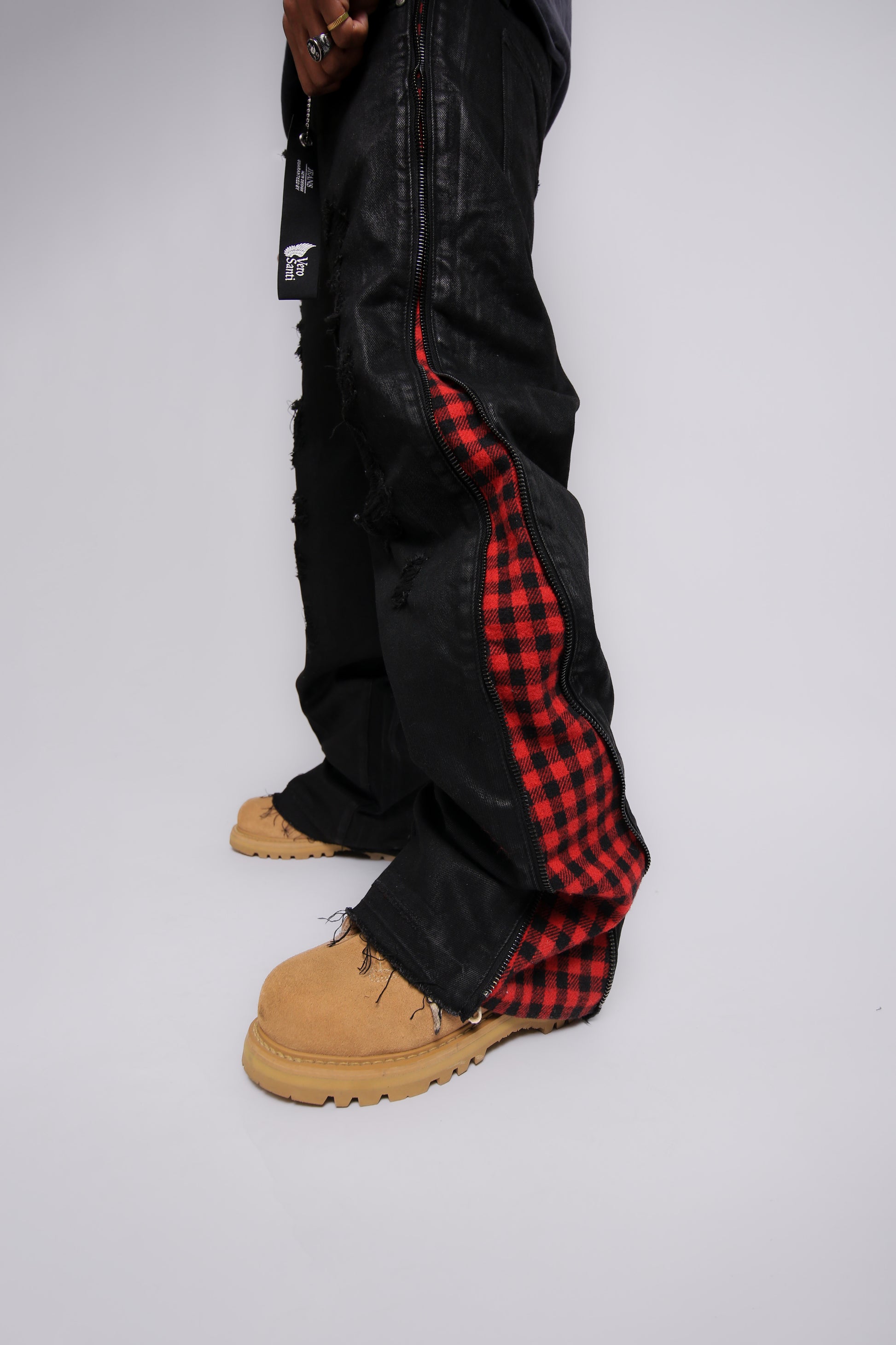 Black pants with red plaid pattern on a white background