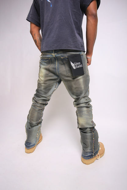 Person wearing distressed jeans with a visible brand logo on a plain background