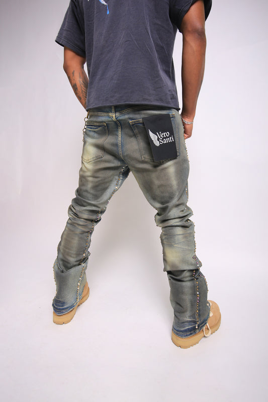 Person wearing distressed jeans with a visible brand logo on a plain background