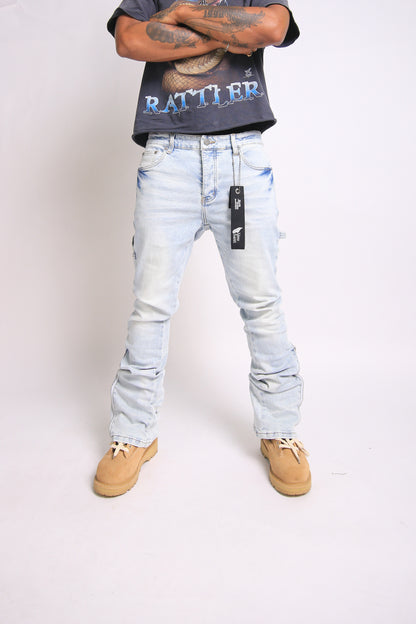 Light blue jeans with brand tag worn by a person on a white background