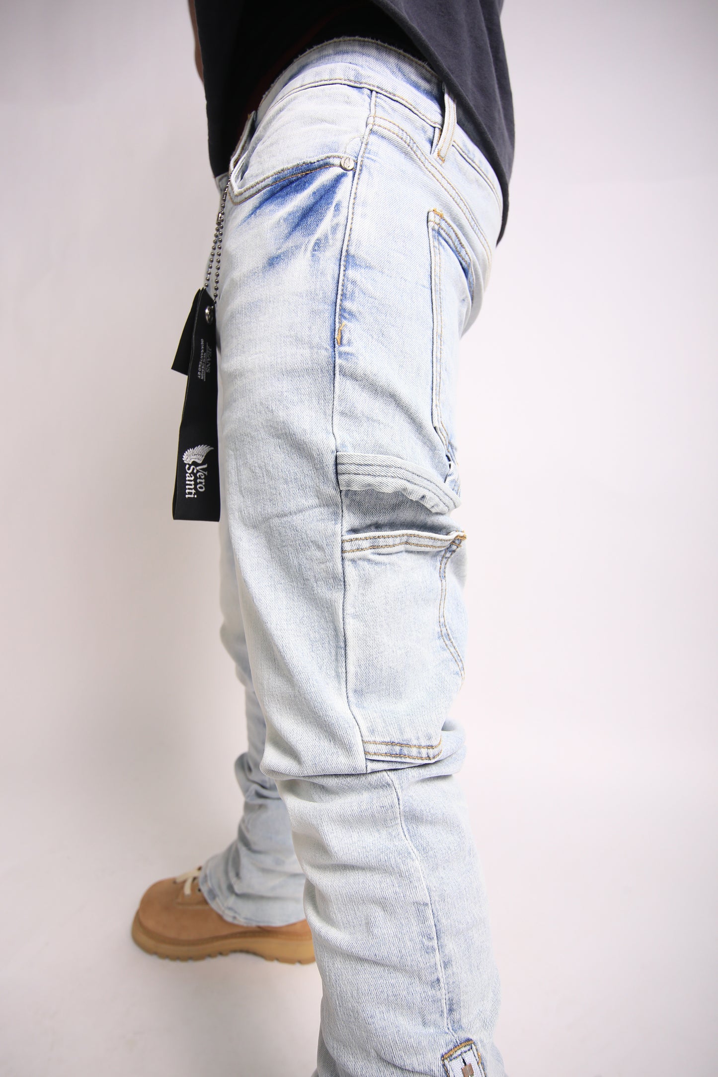 Light blue distressed jeans worn by a person on a white background