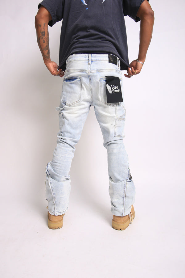 Person wearing light blue jeans with a visible brand logo on a white background