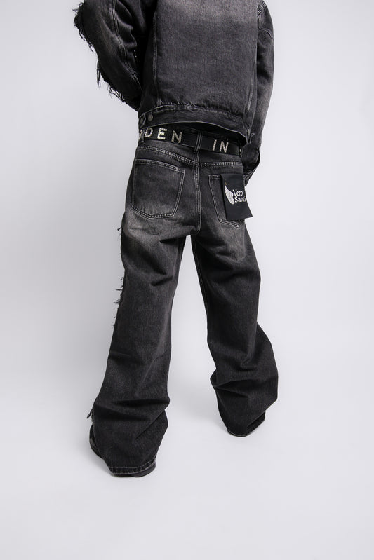 Person wearing black jeans with visible branding on a white background