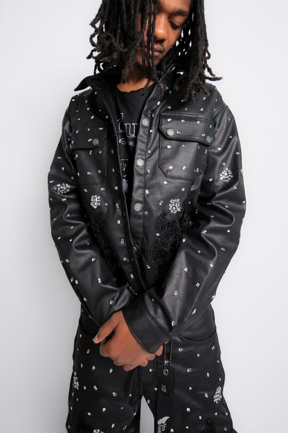 Person wearing a black leather jacket with white patterns on a white background
