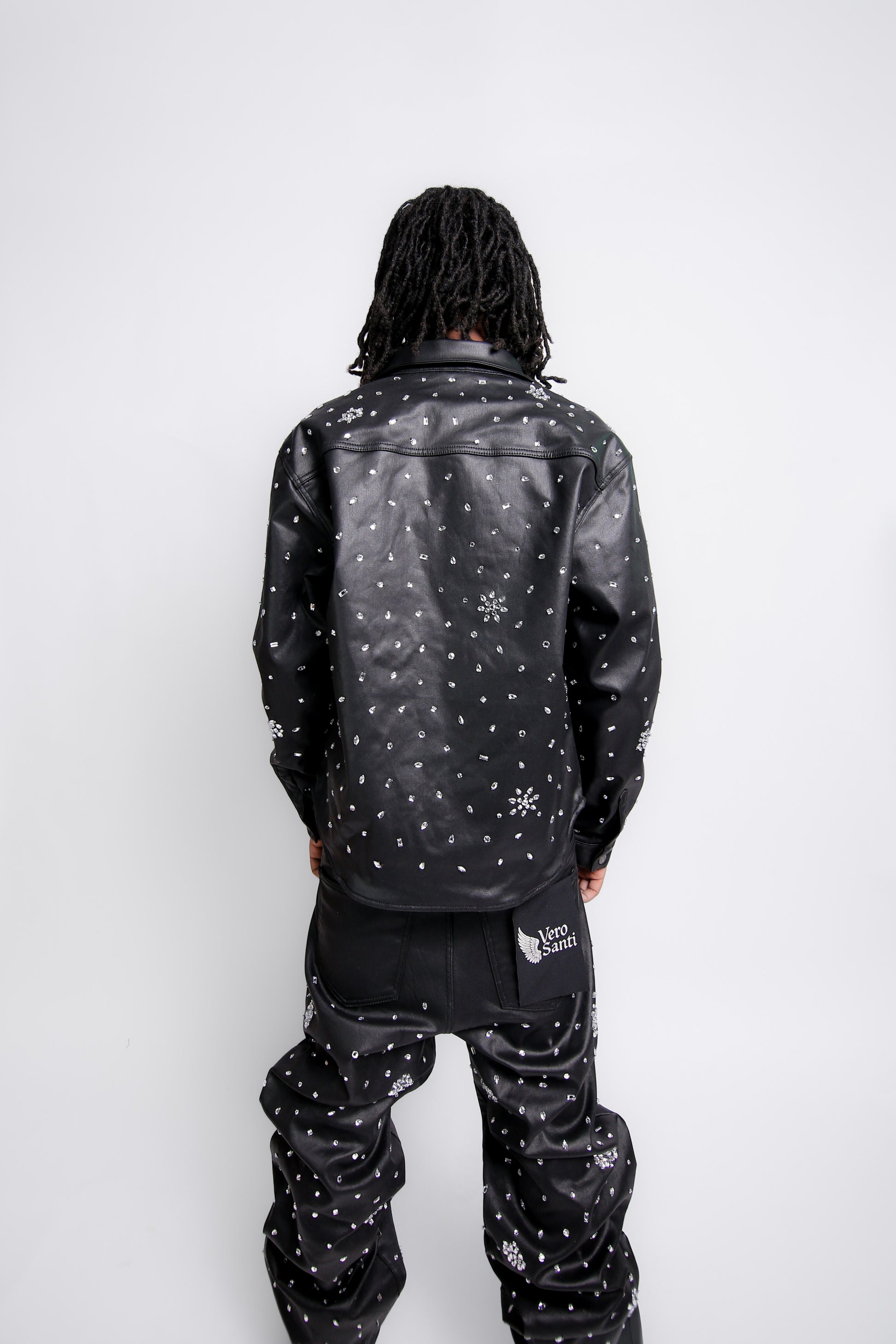 Person wearing a black jacket with white patterns on a white background