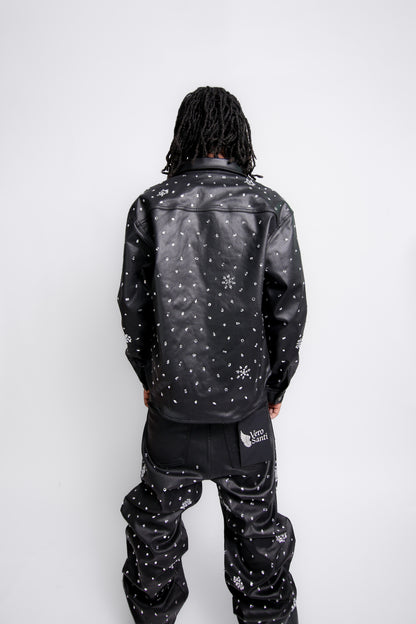 Person wearing a black jacket with white patterns on a white background