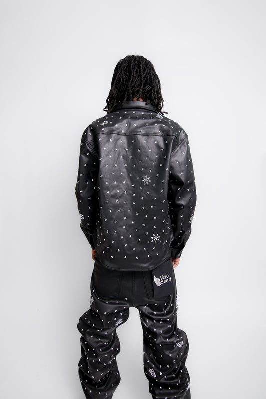 Person wearing a black jacket with white patterns on a white background