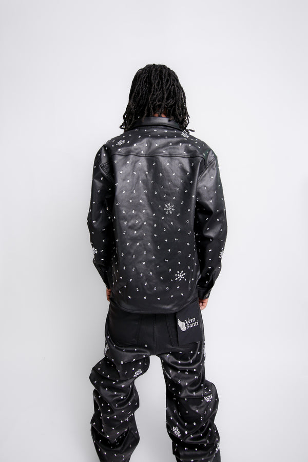 Person wearing a black jacket with white patterns on a white background