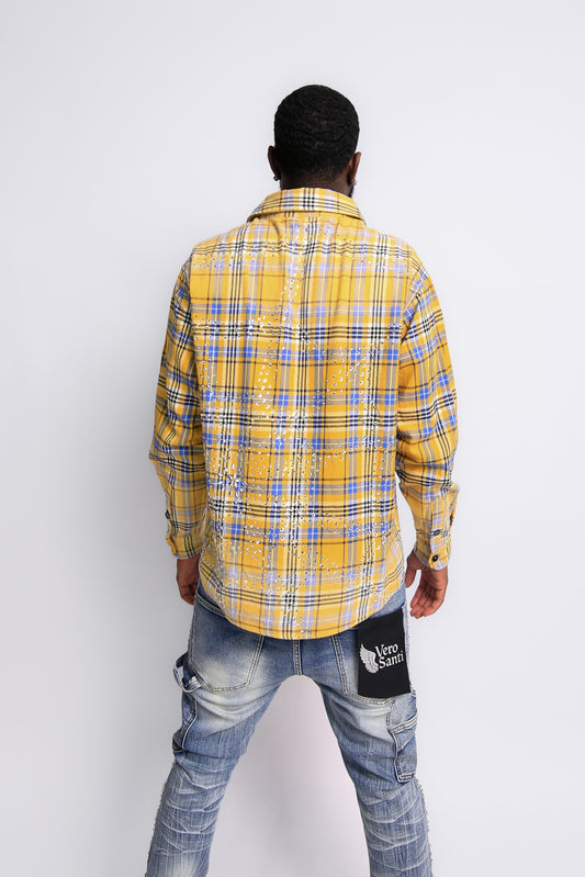 Person wearing a yellow and blue plaid shirt with a white background