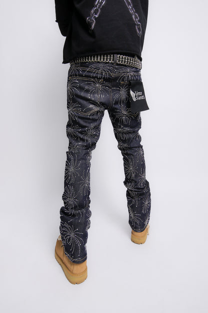 Person wearing dark patterned pants on a white background