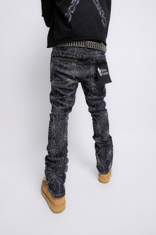 Person wearing dark patterned pants on a white background