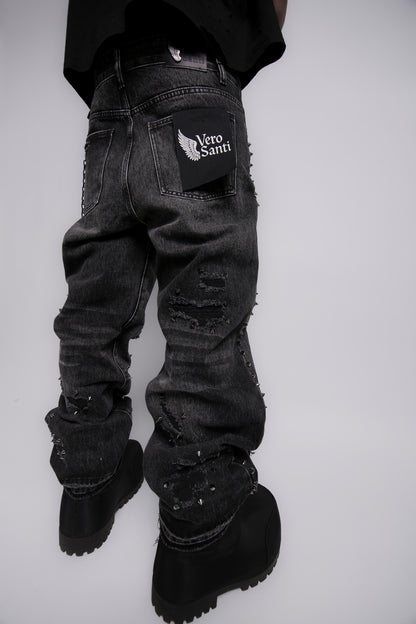 Black distressed jeans with a brand logo on a white background