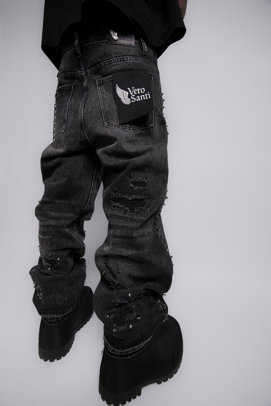 Black distressed jeans with a brand logo on a white background