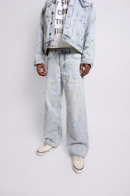 Person wearing a light blue denim outfit with white sneakers on a plain background