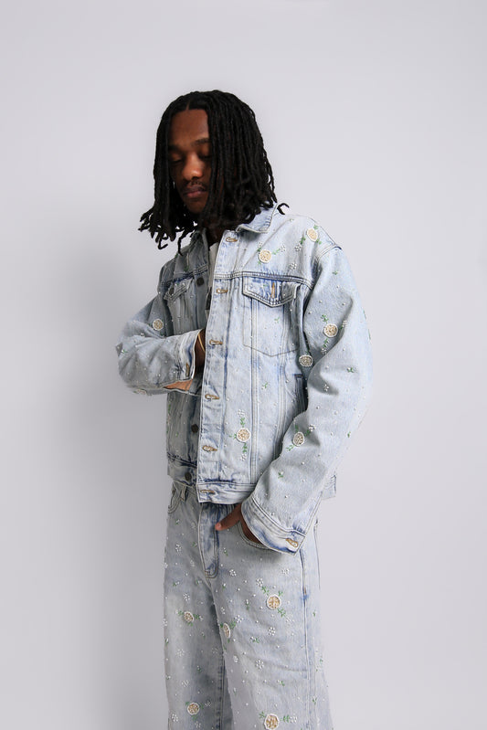 Person wearing a light blue denim jacket and pants on a white background